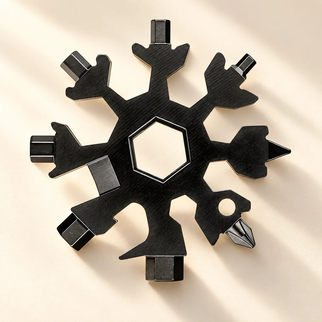 Black Snowflake Multi-Tool, front view on an ivory background